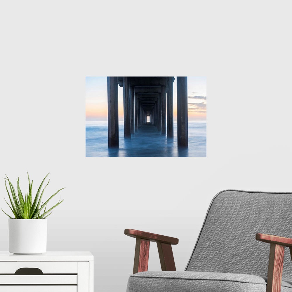 A modern room featuring Photograph underneath the Scripps Pier at sunset.