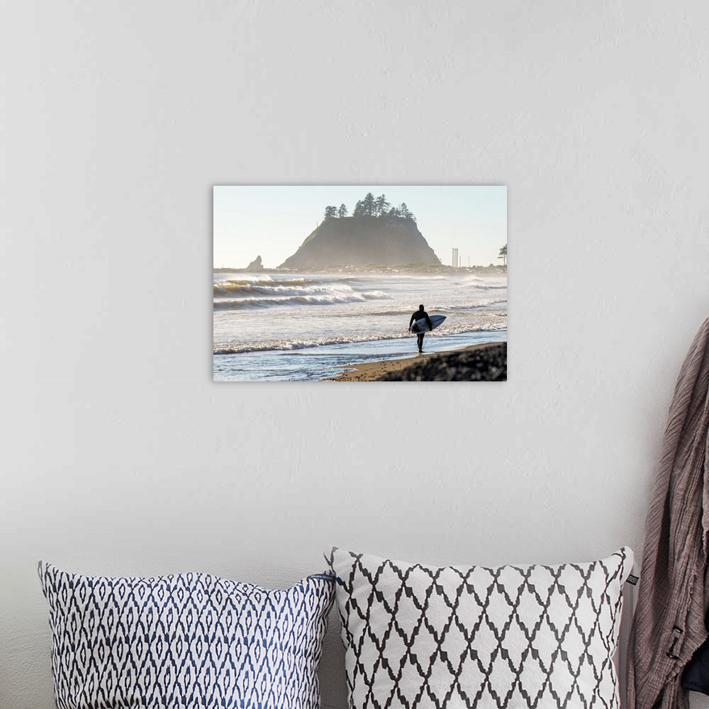 A bohemian room featuring Photograph of a surfer walking on the shore of La Push Beach in Washington, with misty cliffs in ...