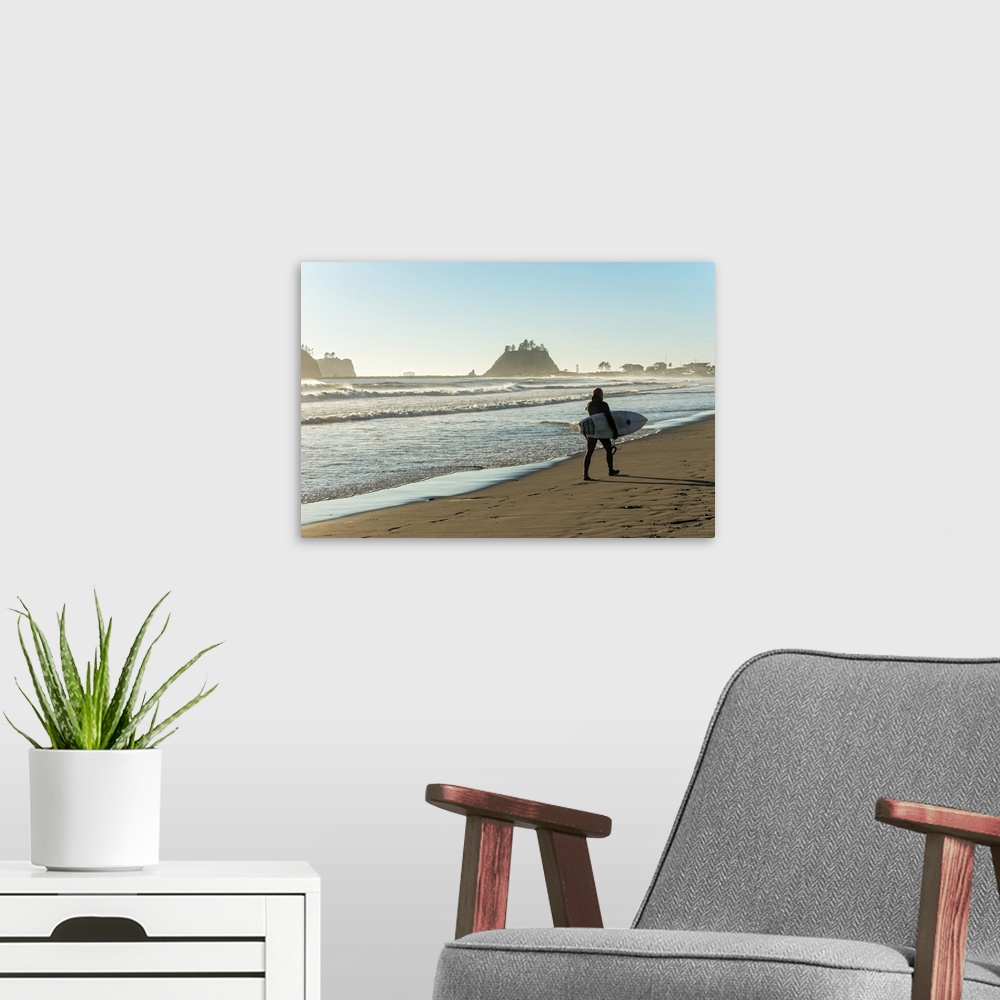 A modern room featuring Photograph of a surfer walking along the shore at La Push Beach in Washington.