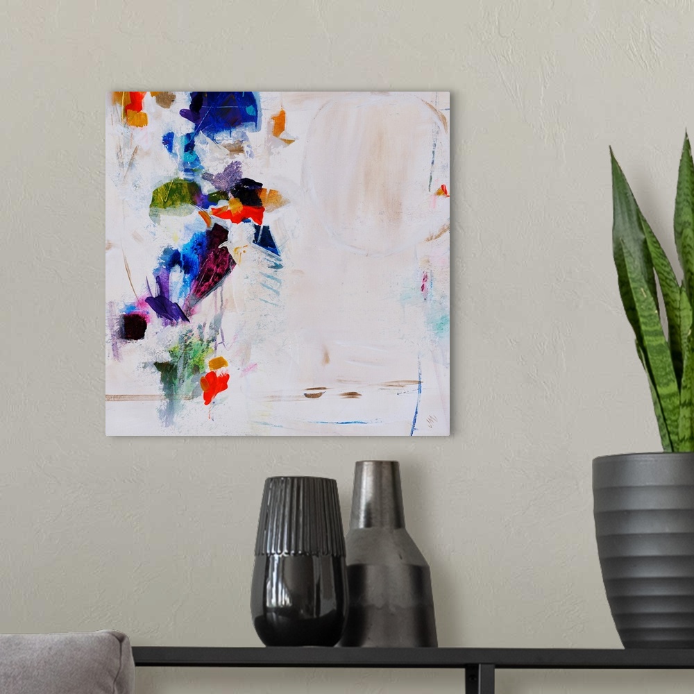 A modern room featuring Abstract painting featuring vibrant splotches of color over a neutral background.