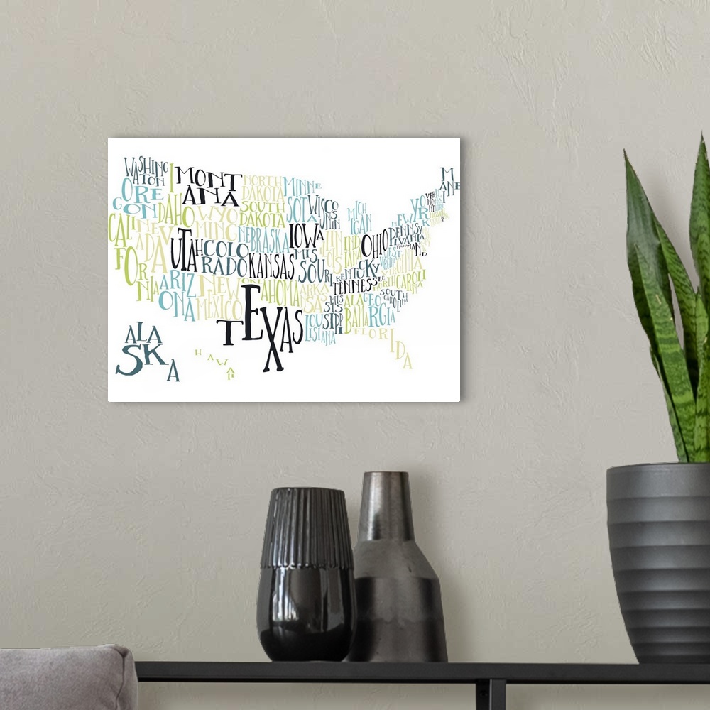 A modern room featuring A hand-drawn typography map of the United States with all the state names, in yellow, green, and ...
