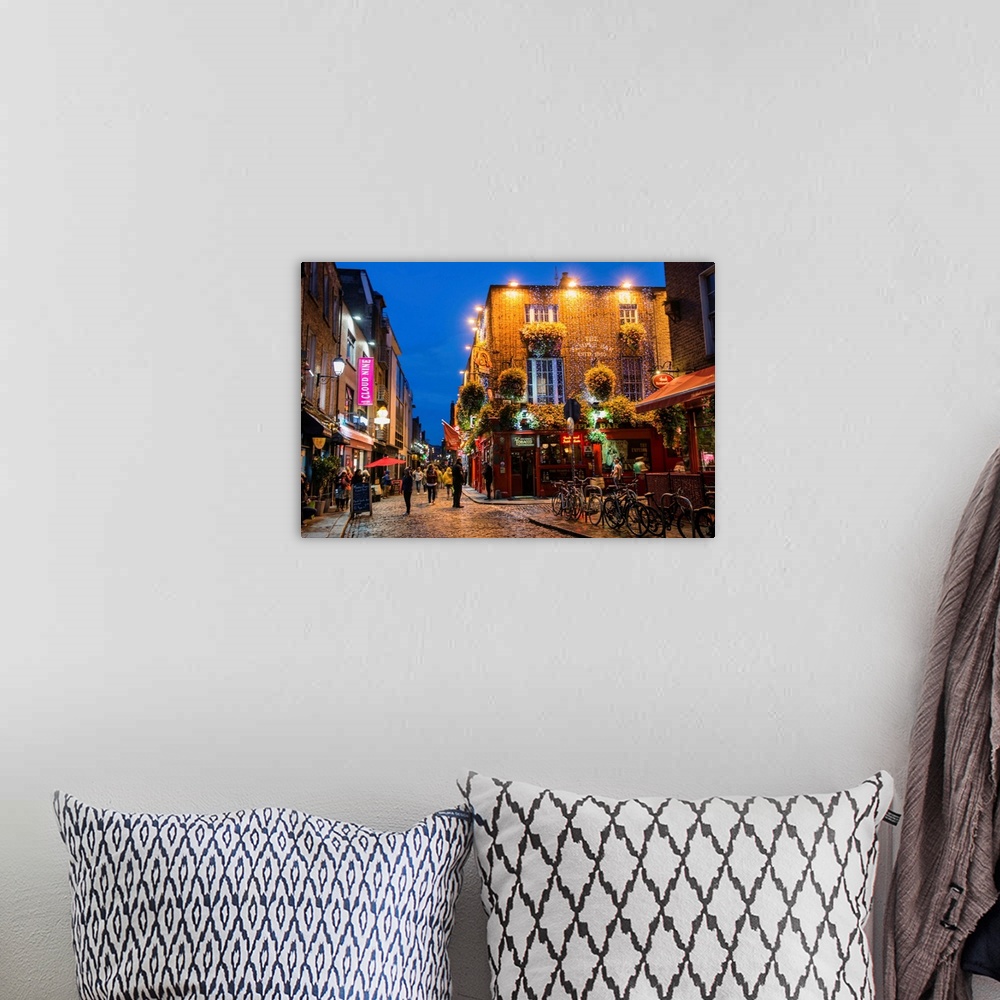 A bohemian room featuring Photograph of Temple Bar, a busy riverside neighborhood in Dublin, Ireland, at night.