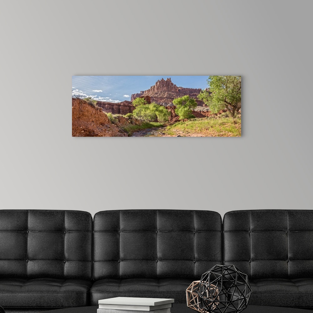 A modern room featuring View of 'The Castle' rock formation near a stream at Capitol Reef National Park.