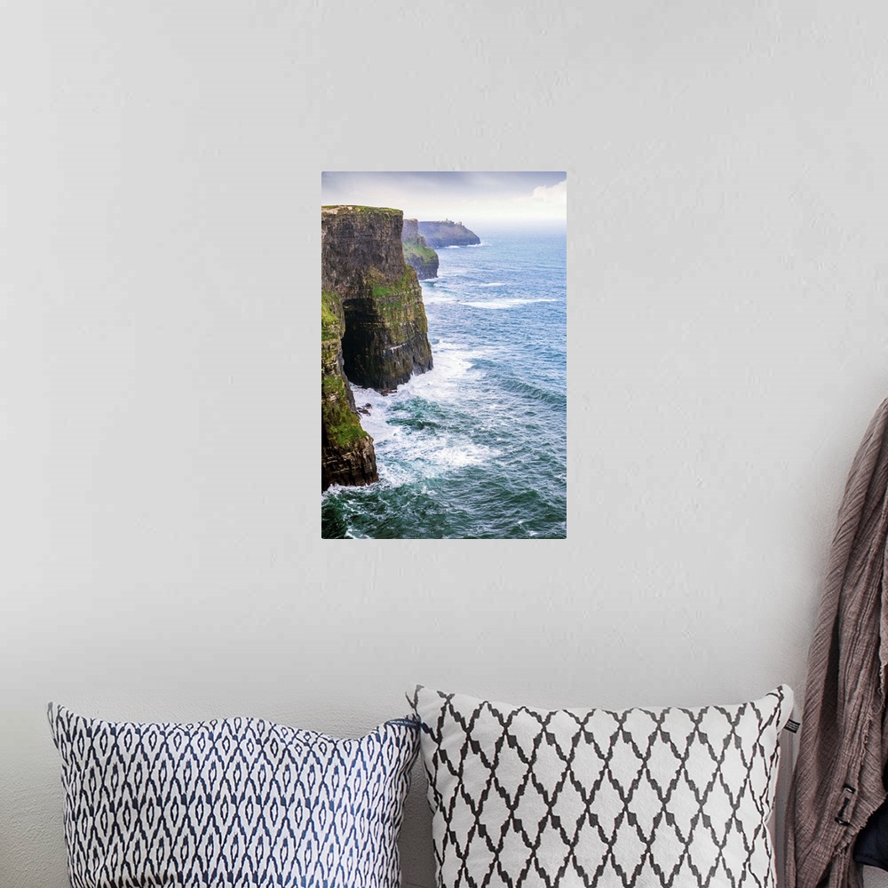 A bohemian room featuring Landscape photograph of the picturesque Cliffs of Moher, located at the southwestern edge of the ...