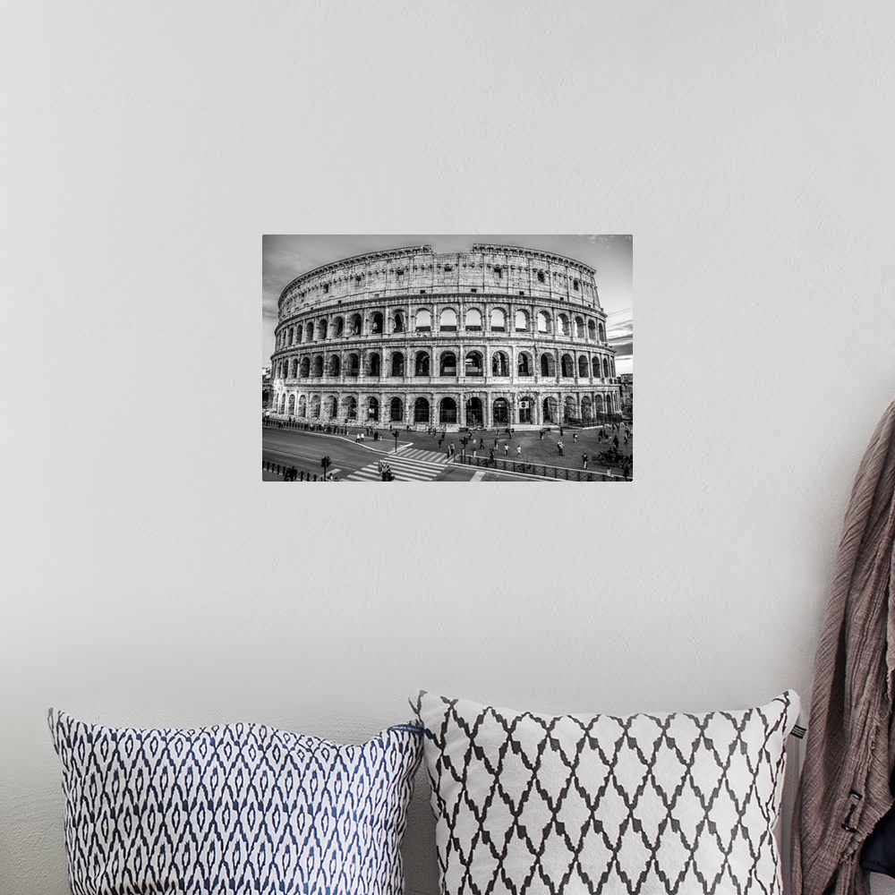 A bohemian room featuring Photograph of the Colosseum lit up at dusk.