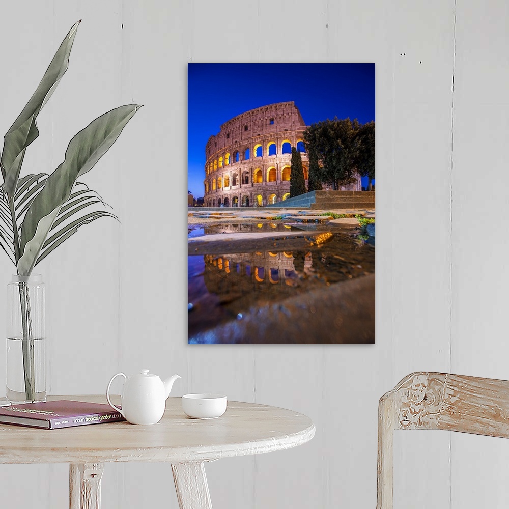 A farmhouse room featuring Photograph of the Colosseum at night reflecting into a puddle on the ground.