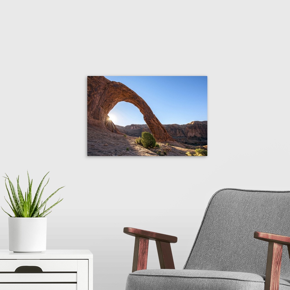 A modern room featuring Sunlight shining on the desert landscape around the Corona Arch, Arches National Park, Utah.