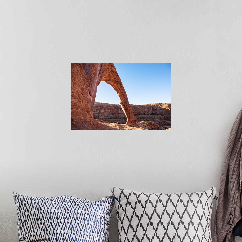 A bohemian room featuring Sunlight shining on the desert landscape around the Corona Arch, Arches National Park, Utah.