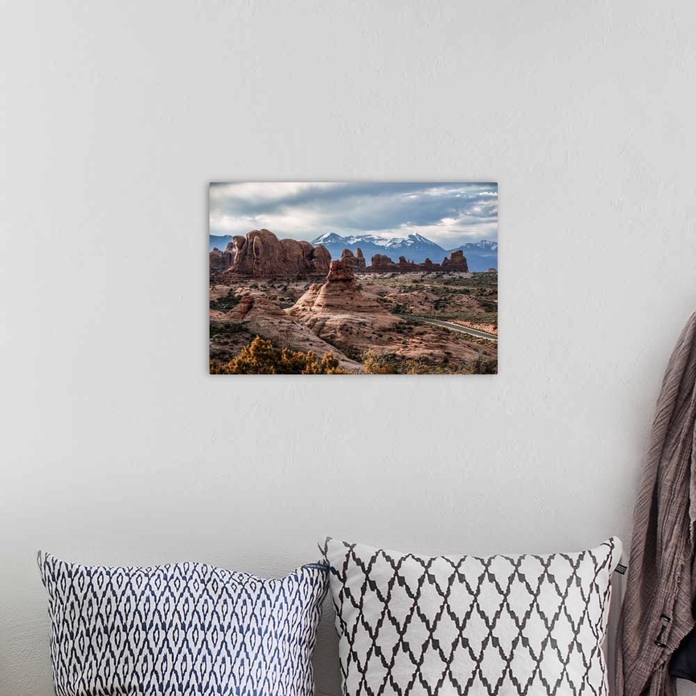 A bohemian room featuring Fiery Furnace sandstone rock formations with the La Sal Mountains in the distance, Arches Nationa...