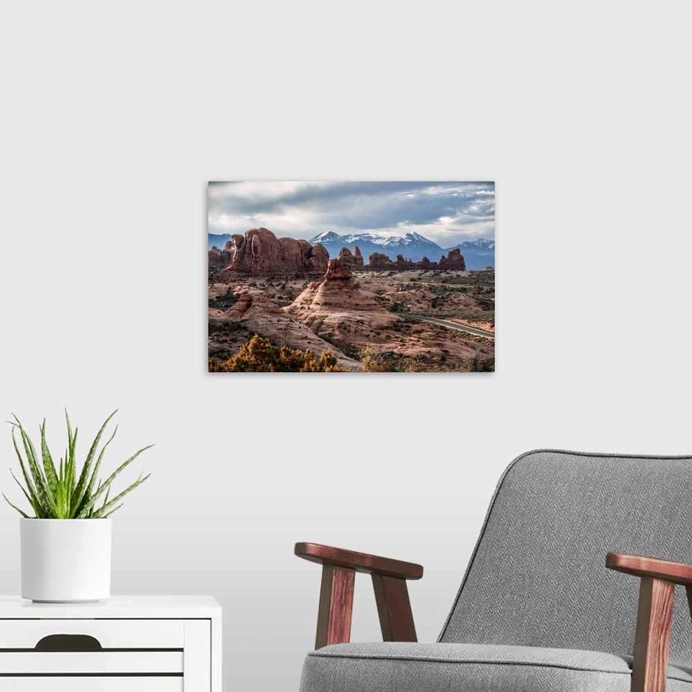 A modern room featuring Fiery Furnace sandstone rock formations with the La Sal Mountains in the distance, Arches Nationa...
