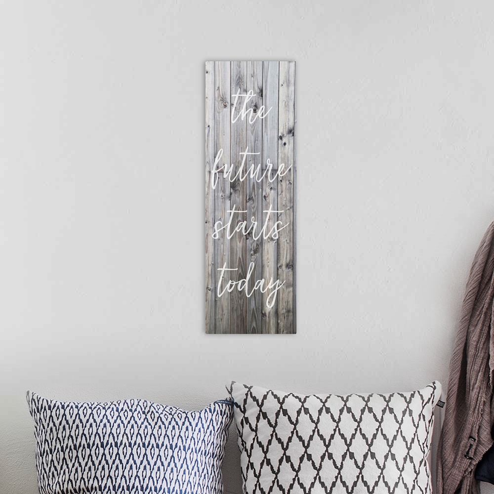A bohemian room featuring Motivational sentiment written on a banner, over grey wooden planks.
