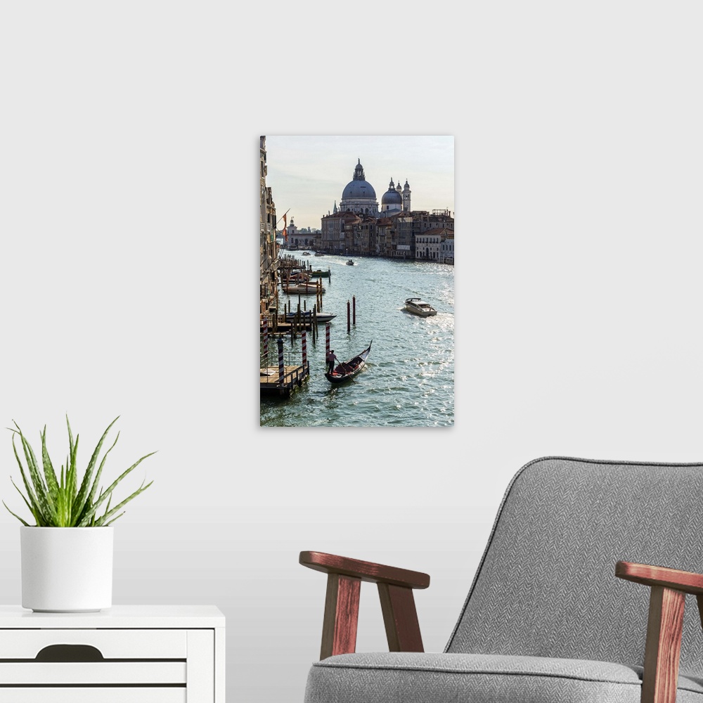 A modern room featuring Landscape photograph of gondolas and boats on the Grand Canal with Santa Maria della Salute in th...