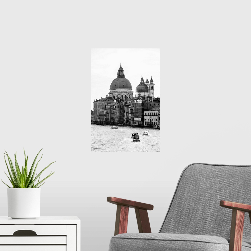 A modern room featuring Landscape photograph of gondolas and boats on the Grand Canal with Santa Maria della Salute in th...