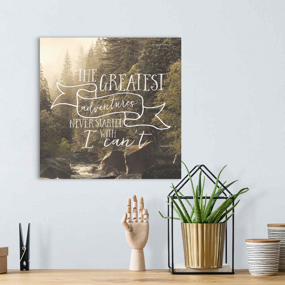 A bohemian room featuring Handwritten motivational sentiment over an image of a forest stream.