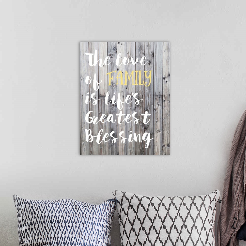 A bohemian room featuring "The love of family is life's greatest blessing" in hand-lettered text over a background of woode...