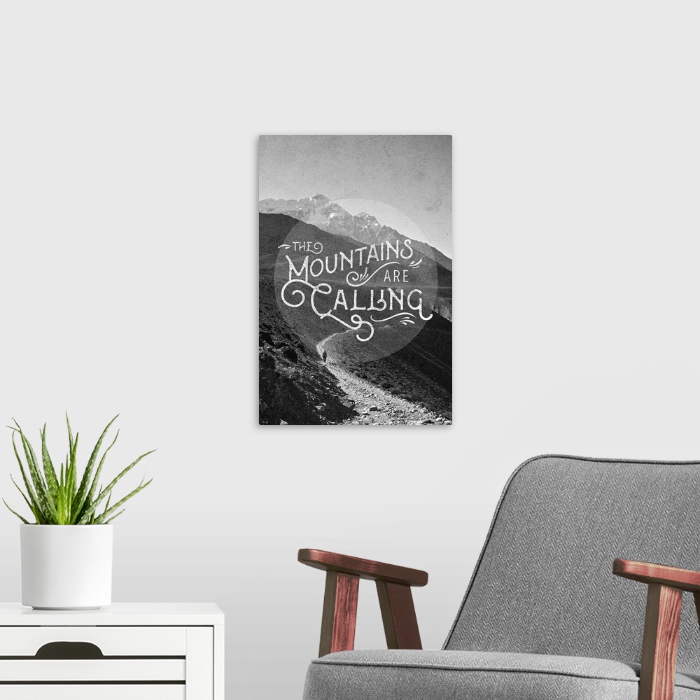 A modern room featuring Contemporary typography art against a black and white image of a mountainous wilderness scene.