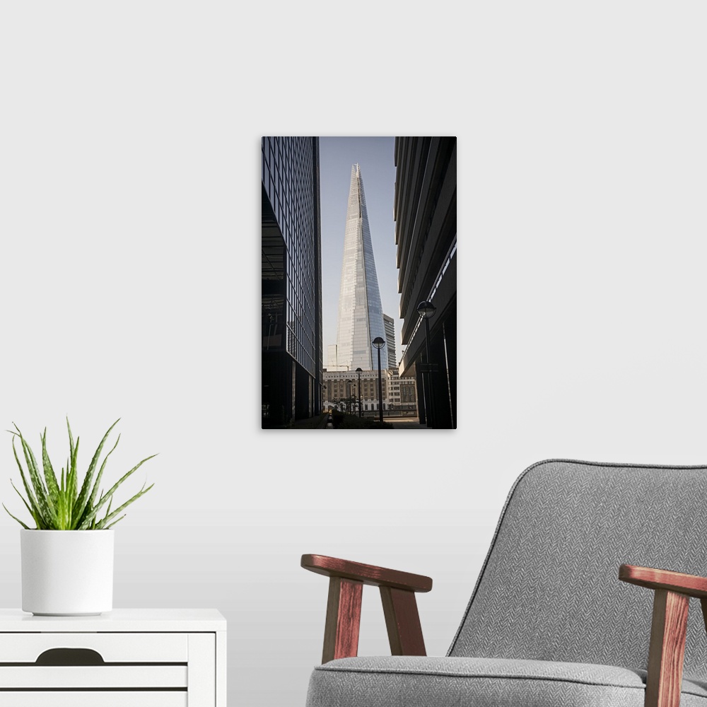 A modern room featuring Photograph of The Shard building in Southwark, London, seen through two other buildings.