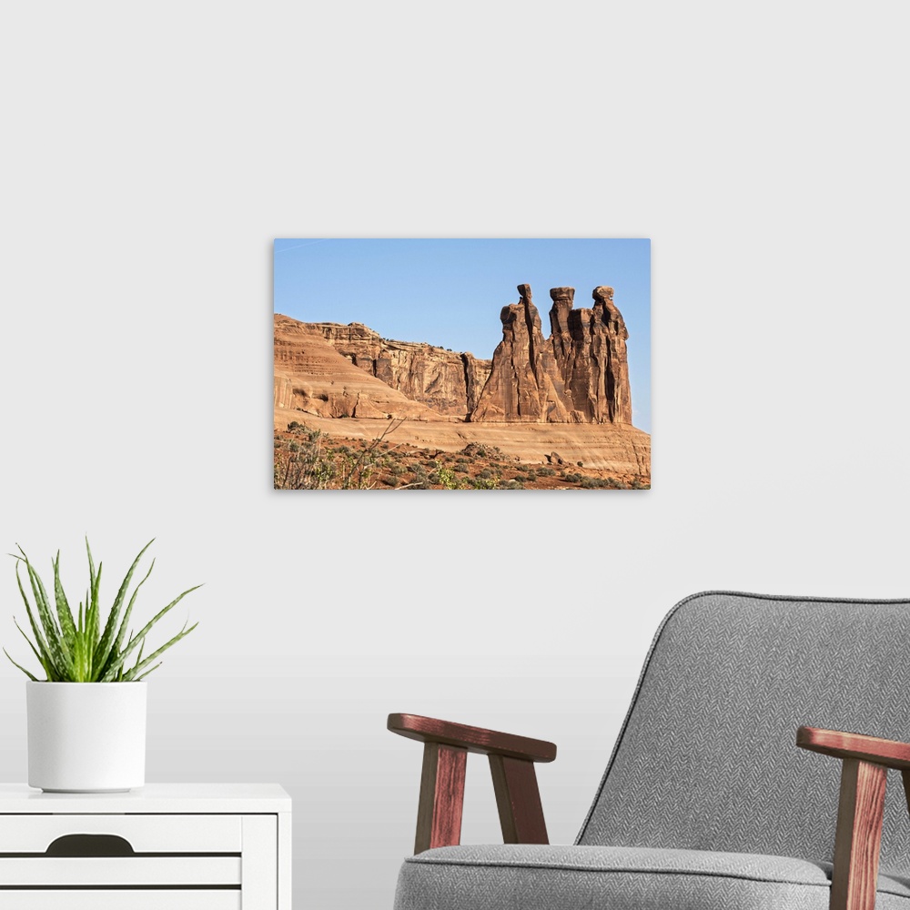 A modern room featuring The Three Gossips, sandstone formation in the Courthouse Towers area of Arches National Park, Moa...
