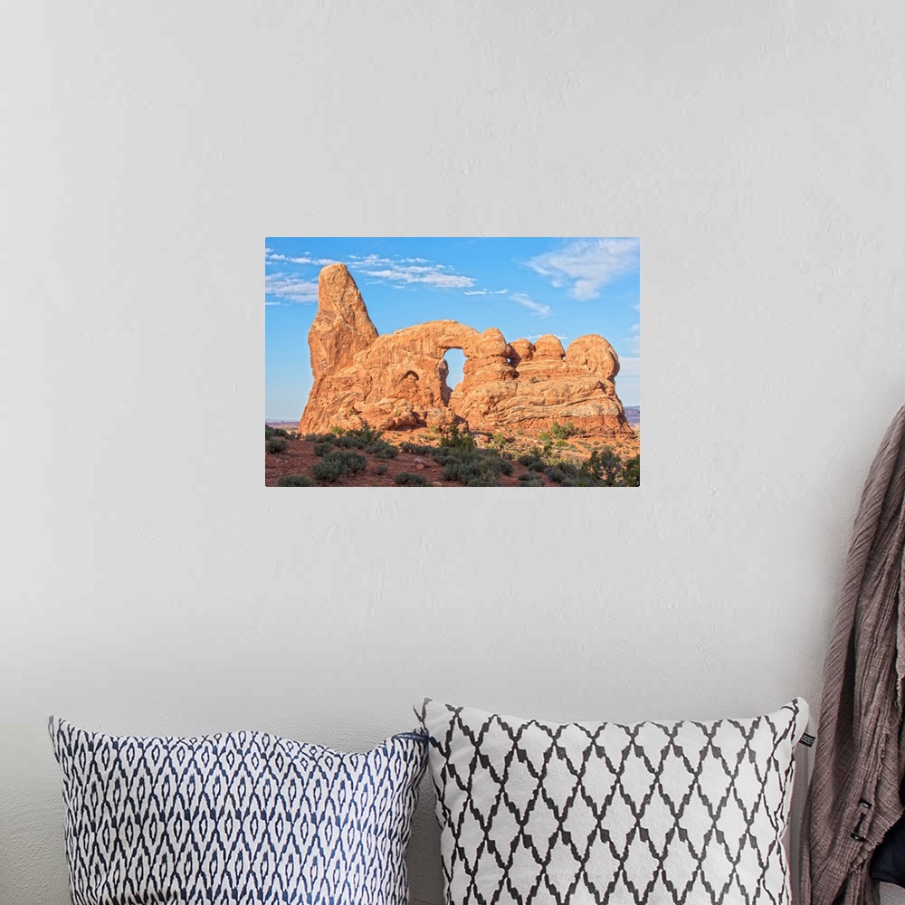 A bohemian room featuring The Turret Arch under a blue sky in Arches National Park, Utah.