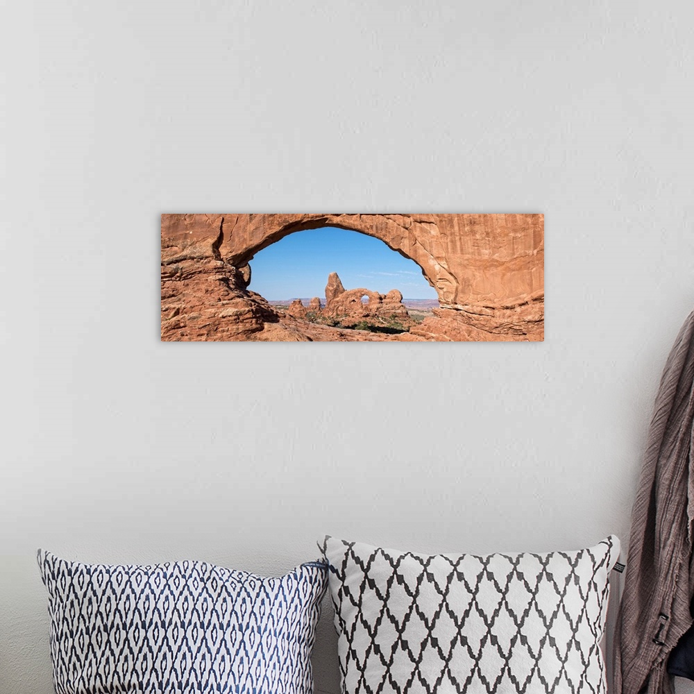 A bohemian room featuring The Turret Arch seen through the North Window Arch, on Windows hiking trail, Arches national Park...