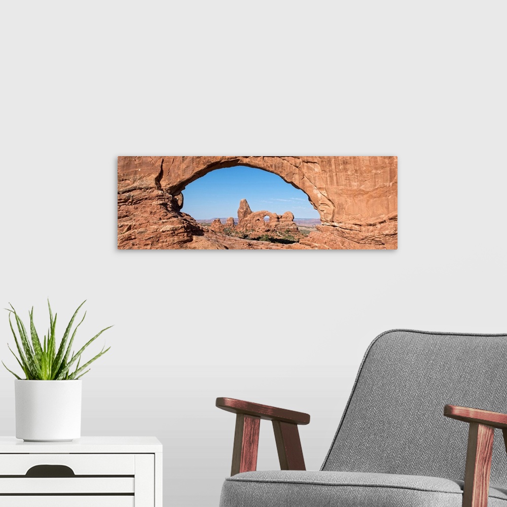 A modern room featuring The Turret Arch seen through the North Window Arch, on Windows hiking trail, Arches national Park...