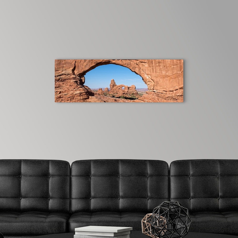 A modern room featuring The Turret Arch seen through the North Window Arch, on Windows hiking trail, Arches national Park...