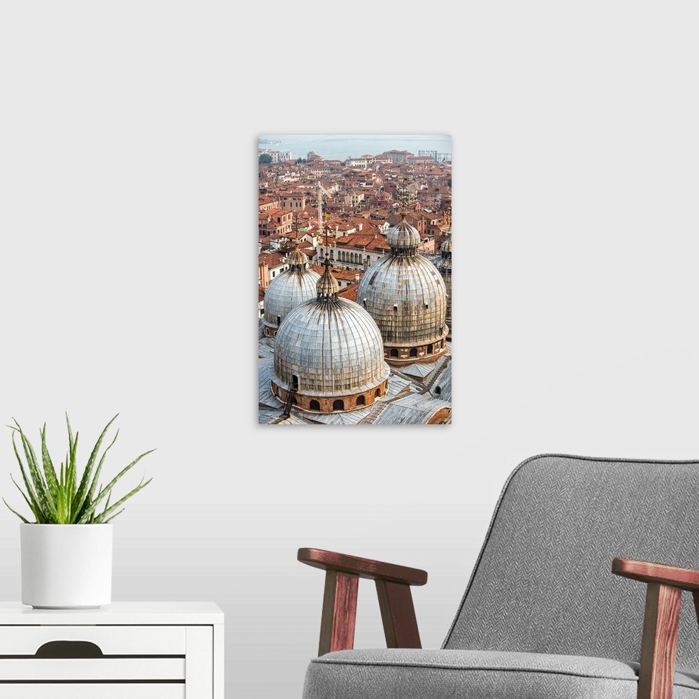 A modern room featuring Aerial view of three domes of San Marco Basilica with Venice rooftops in the background.