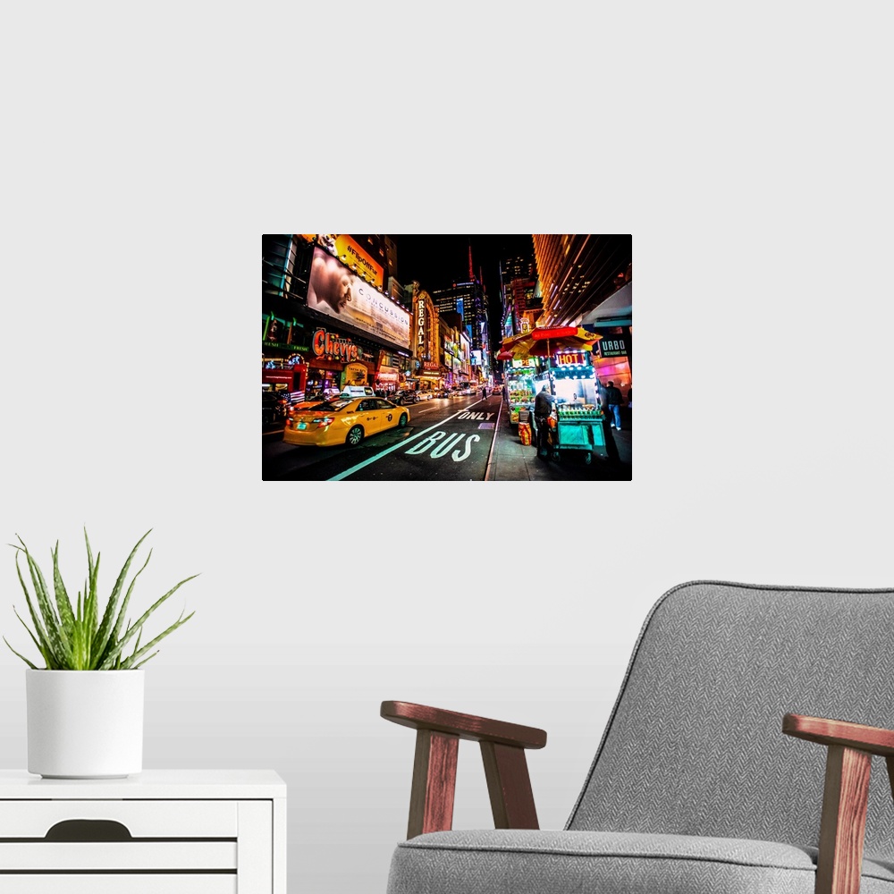 A modern room featuring View of advertising signs on 42nd street in New York city at night.