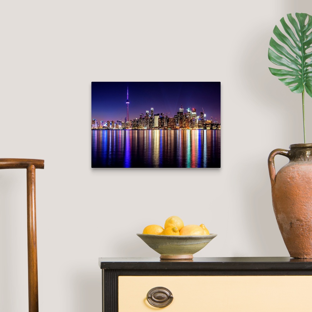 A traditional room featuring Photo of the Toronto city skyline with lights reflected in the water at night.