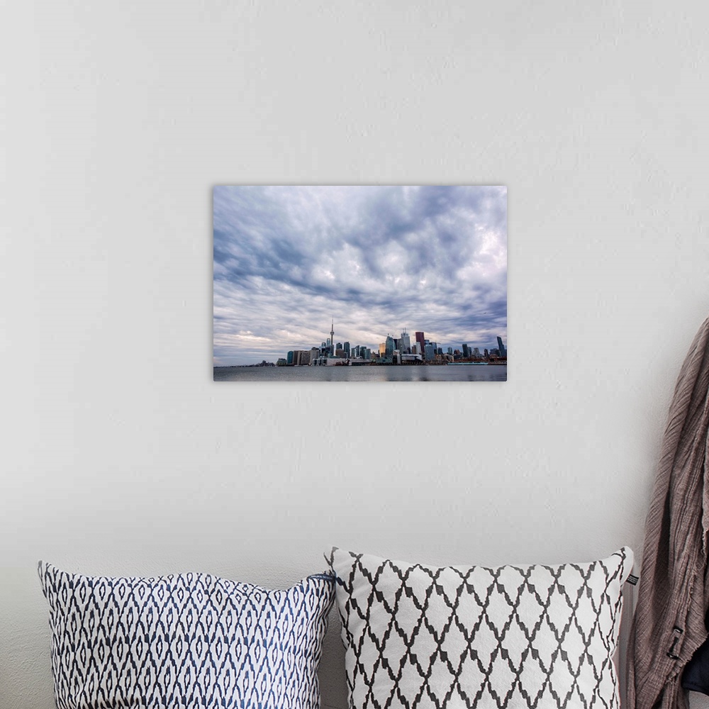 A bohemian room featuring Toronto city skyline under dramatic clouds, Ontario, Canada.