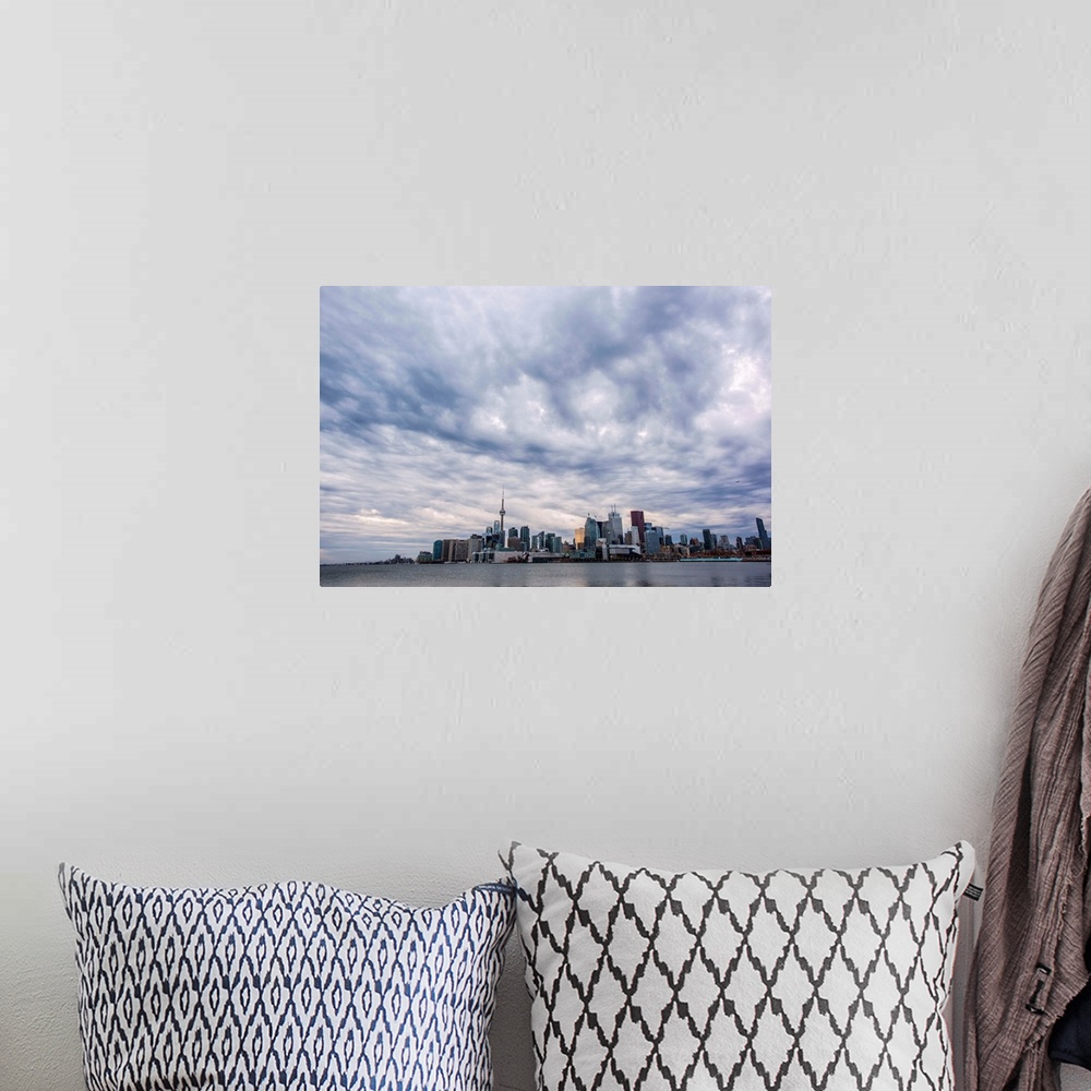 A bohemian room featuring Toronto city skyline under dramatic clouds, Ontario, Canada.