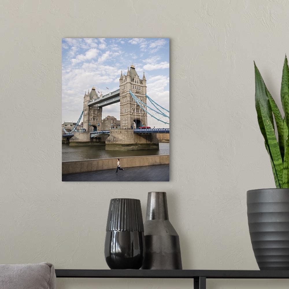 A modern room featuring Photograph of Tower Bridge over River Thames with a double decker bus driving through it.