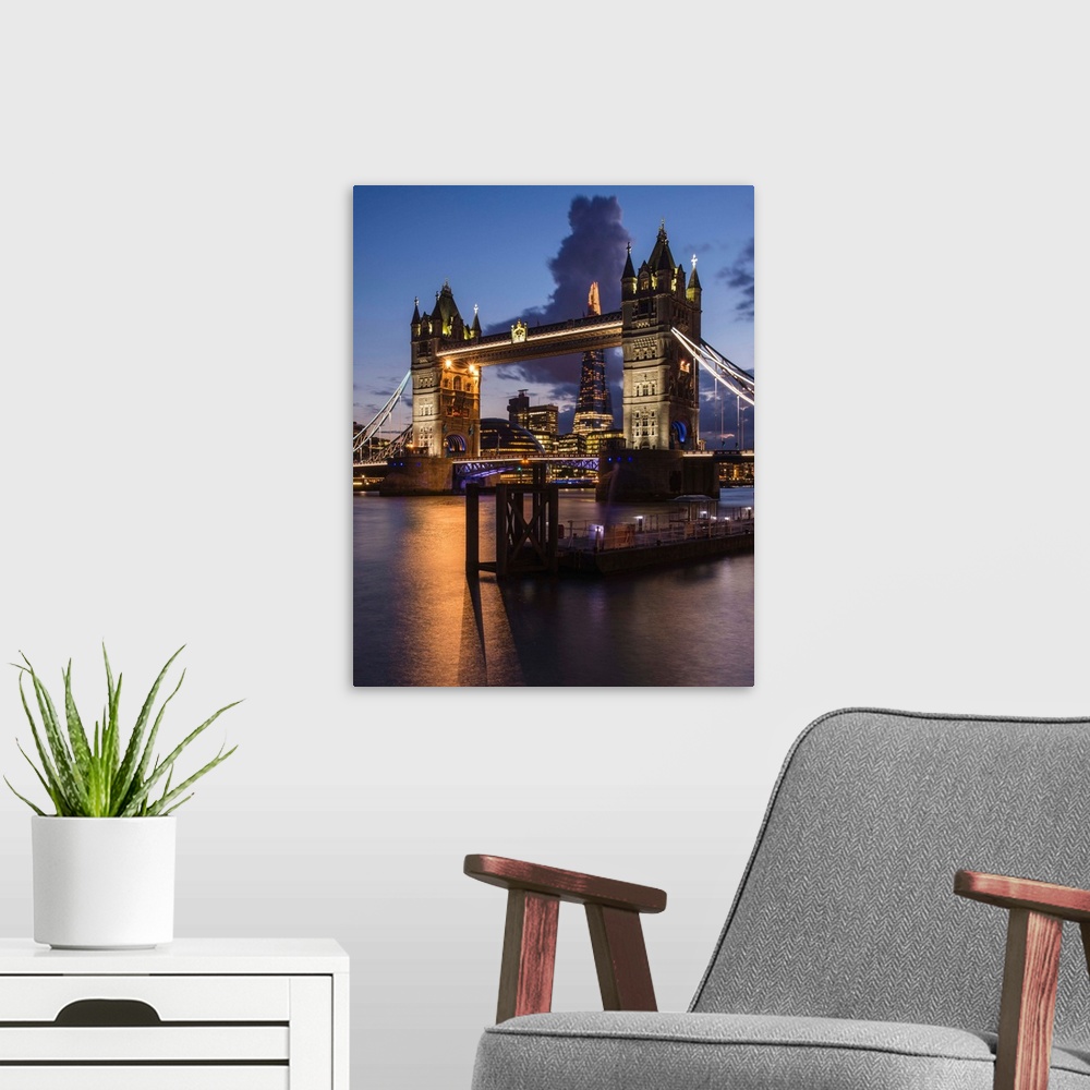 A modern room featuring Photograph of Tower Bridge over River Thames with the Shard Building in the background, all lit u...