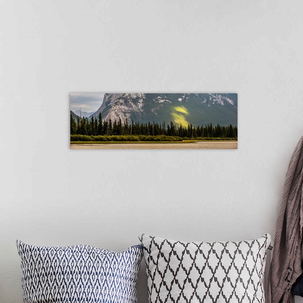 A bohemian room featuring Trees line the edge of Vermilion Lakes in Banff National Park, Alberta, Canada.