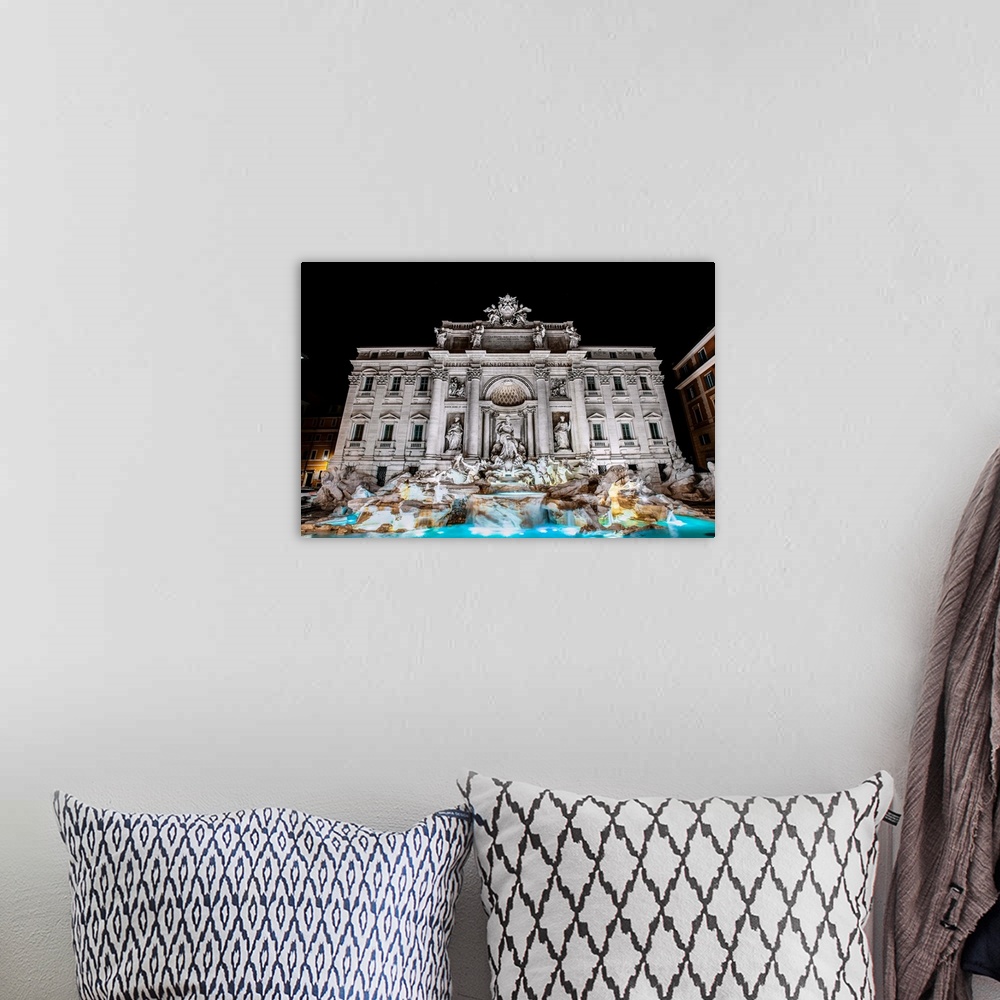 A bohemian room featuring Photograph of the Trevi Fountain in the Trevi district in Rome, Italy, at night.