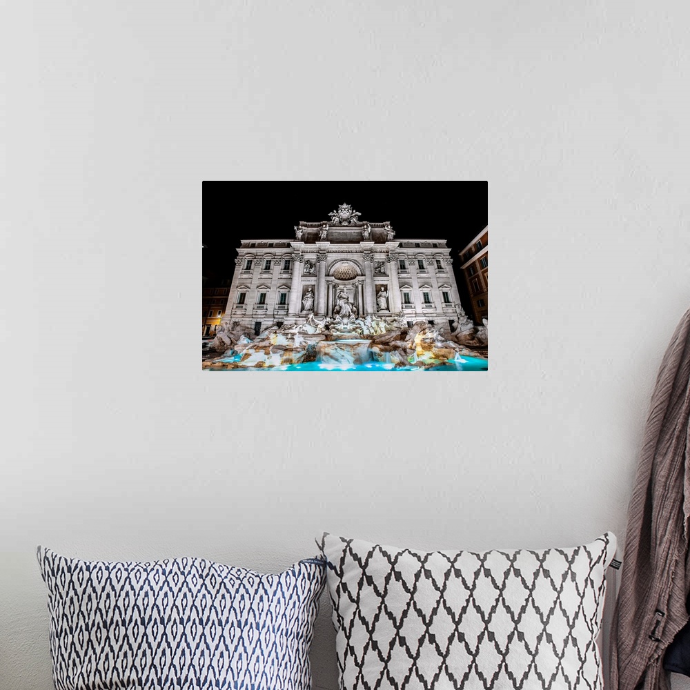 A bohemian room featuring Photograph of the Trevi Fountain in the Trevi district in Rome, Italy, at night.