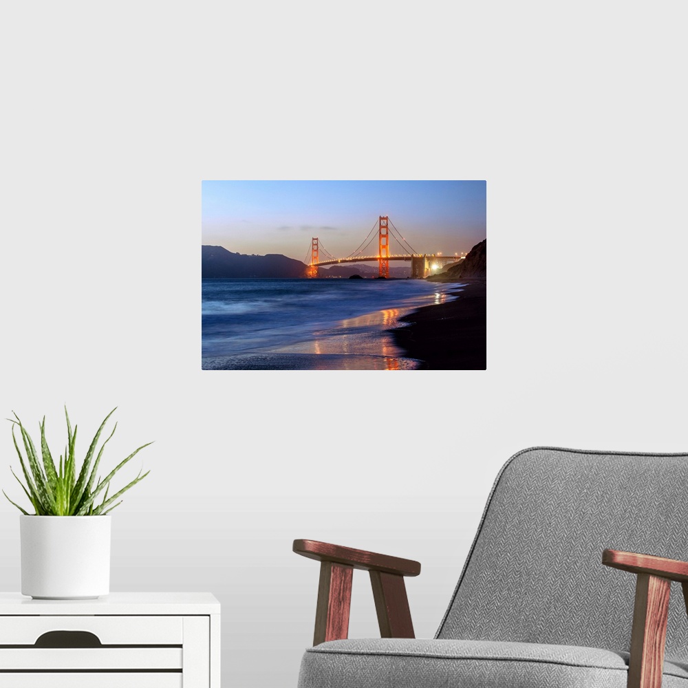 A modern room featuring Twilight photograph of the Golden Gate Bridge taken from the shore.