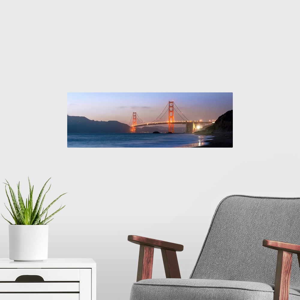 A modern room featuring Panoramic photograph at twilight of the Golden Gate Bridge taken from the shore.