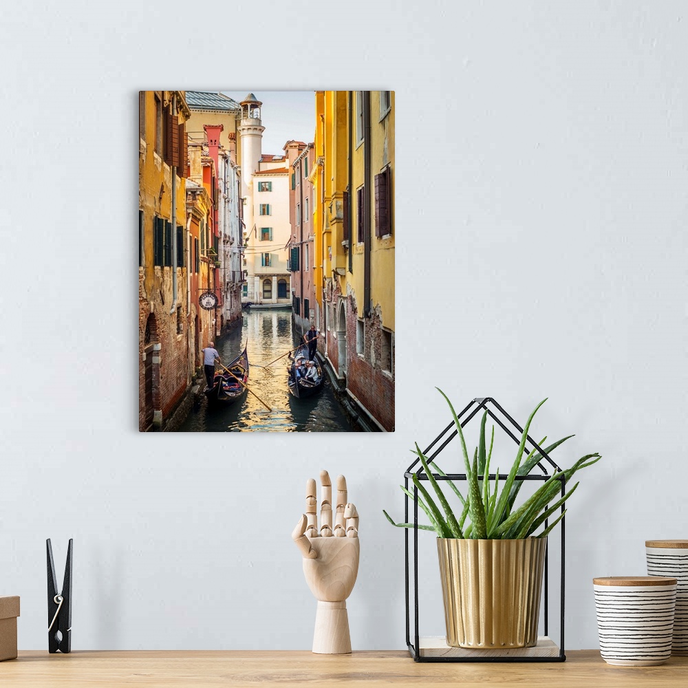 A bohemian room featuring Photograph of two gondolas passing each other through a canal lined with yellow and red buildings...