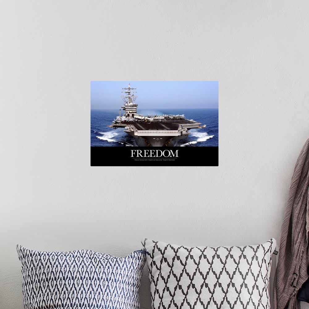 A bohemian room featuring An immense photograph taken of a US navy ship in the open ocean with the word "Freedom" just belo...