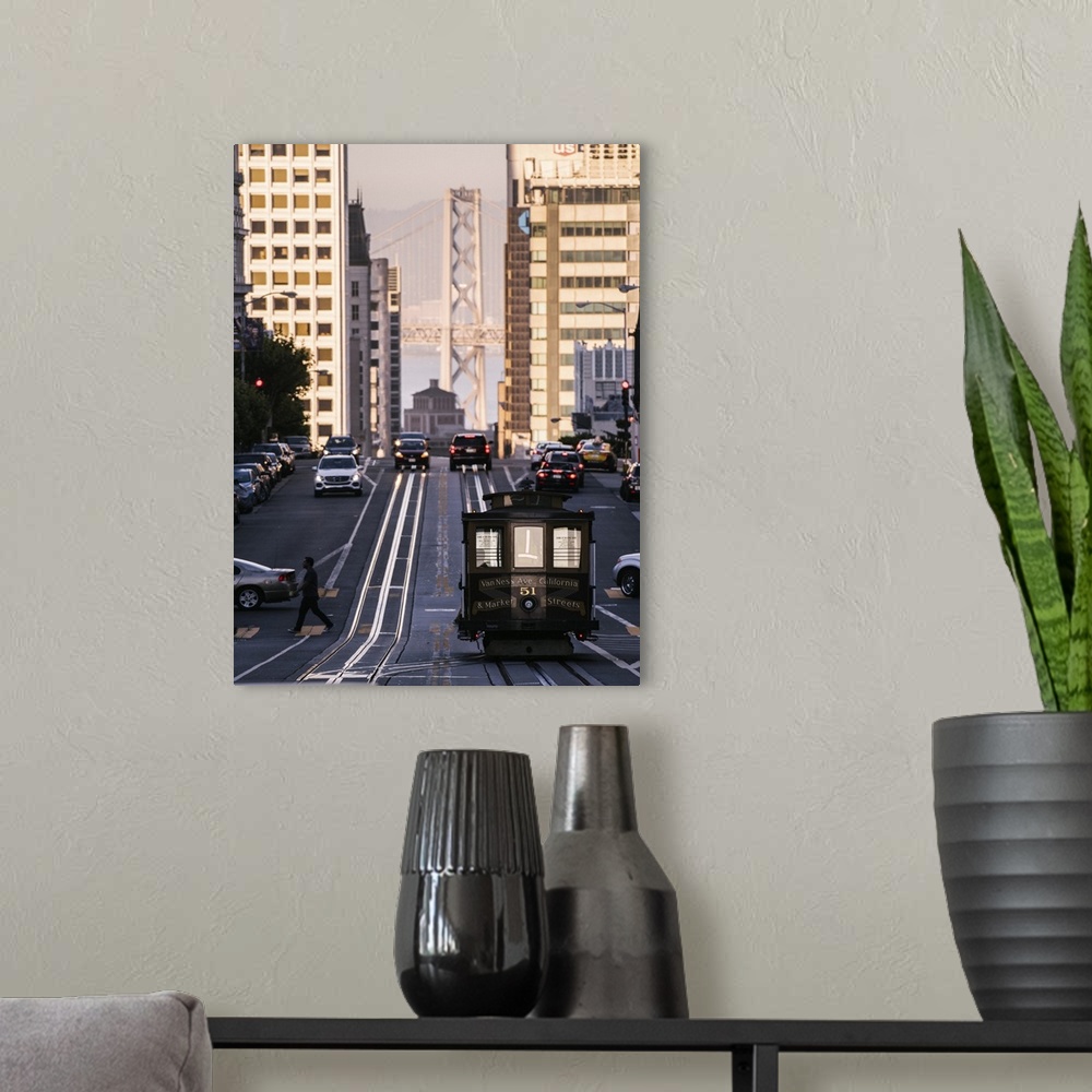 A modern room featuring Photograph of the Van Ness Ave. and Market Streets Trolley with the Bay Bridge in the background.