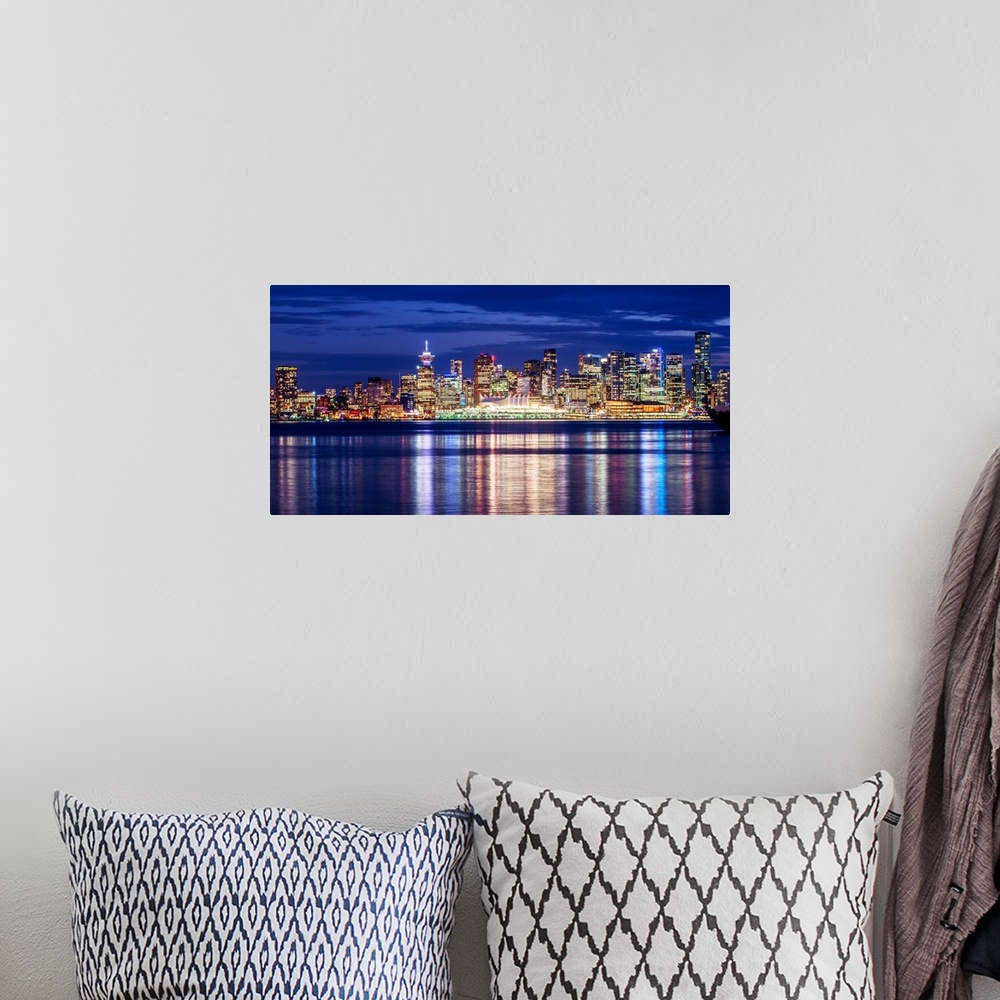 A bohemian room featuring Photograph of the Vancouver, British Columbia skyline lit up on a dark blue night and reflecting ...