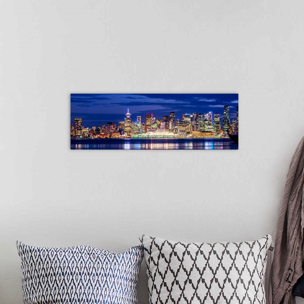 A bohemian room featuring Panoramic photograph of the Vancouver, British Columbia skyline lit up on a dark purple night and...