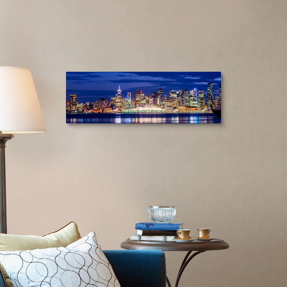 A traditional room featuring Panoramic photograph of the Vancouver, British Columbia skyline lit up on a dark purple night and...