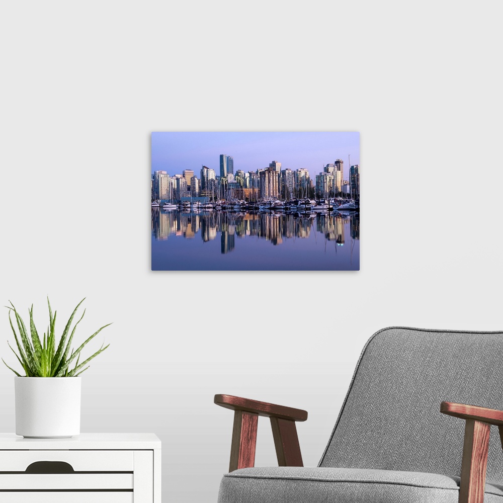 A modern room featuring Photograph of a purple sunset over the Vancouver skyline and harbor reflecting onto the False Cre...