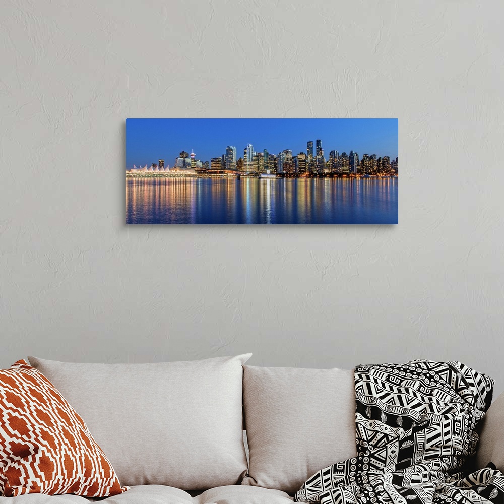 A bohemian room featuring Photograph of the downtown Vancouver skyline lit up at dusk and reflecting onto the water creatin...