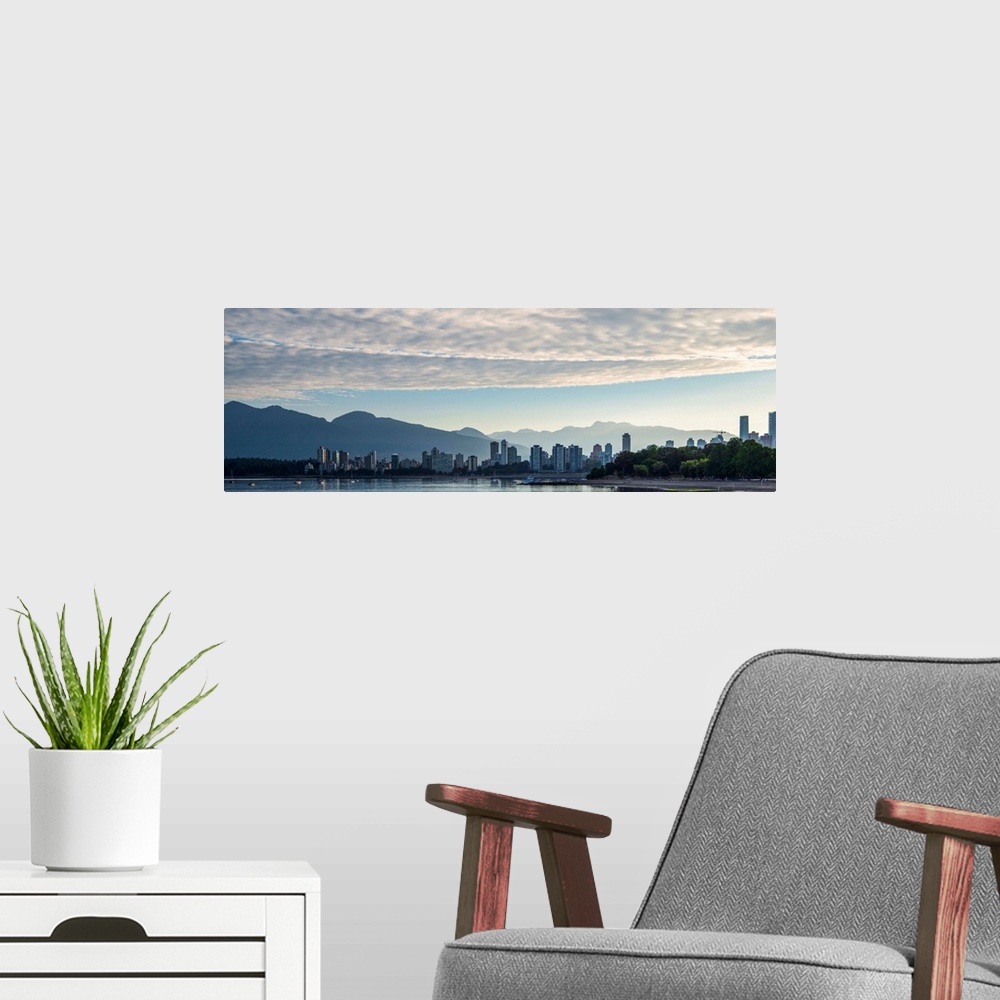 A modern room featuring Panoramic photograph of the Vancouver, British Columbia, Canada skyline at sunset with silhouette...