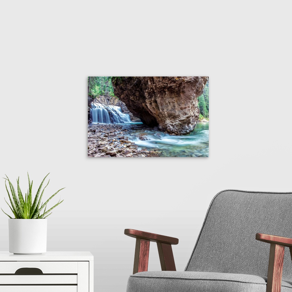 A modern room featuring Waterfall and boulder at Johnston Canyon in Banff National Park, Alberta, Canada.