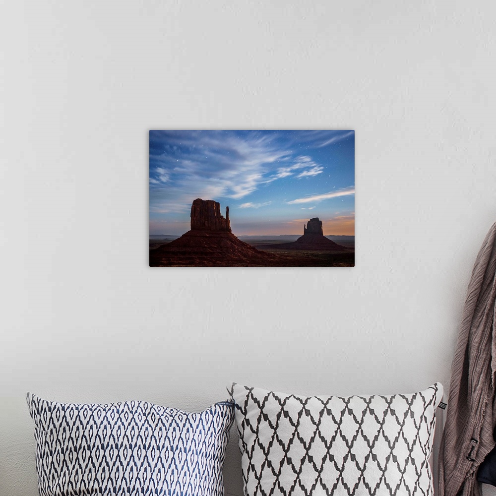 A bohemian room featuring West and East Mitten Butte in Monument Valley after sunset, Arizona.