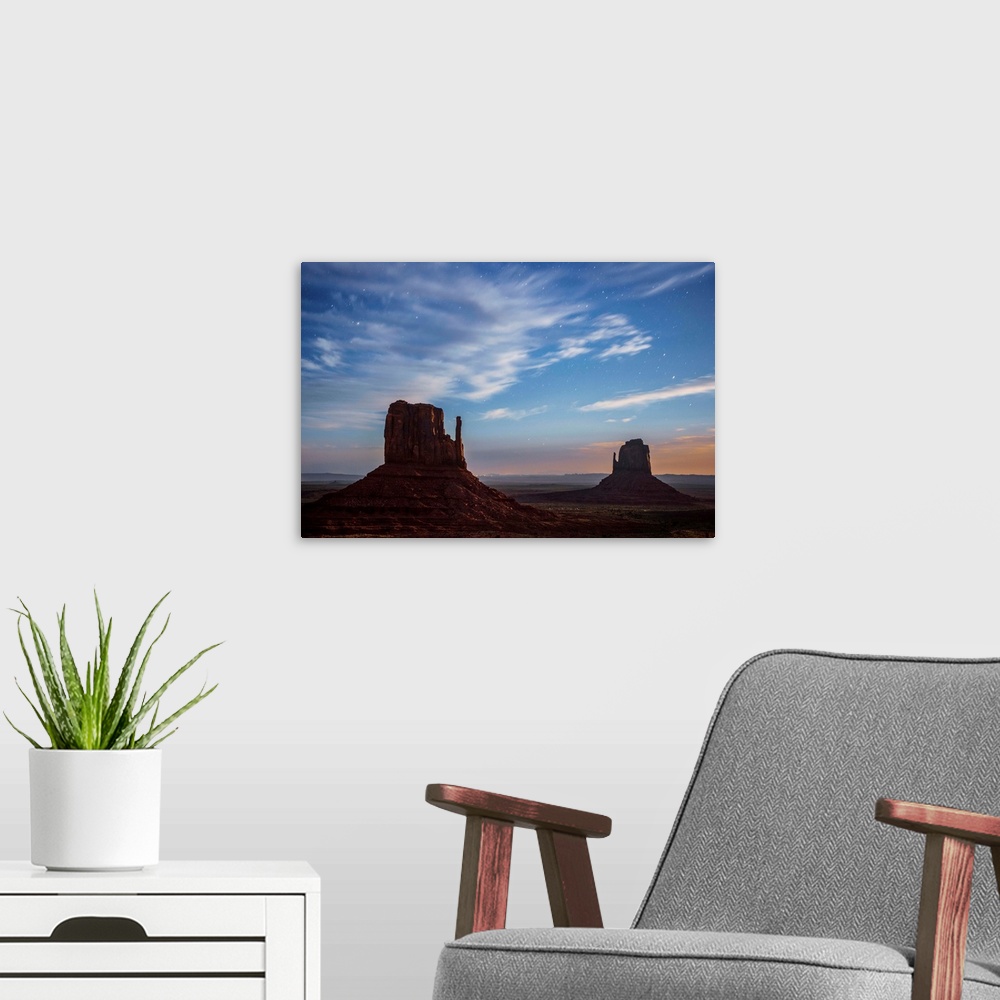 A modern room featuring West and East Mitten Butte in Monument Valley after sunset, Arizona.